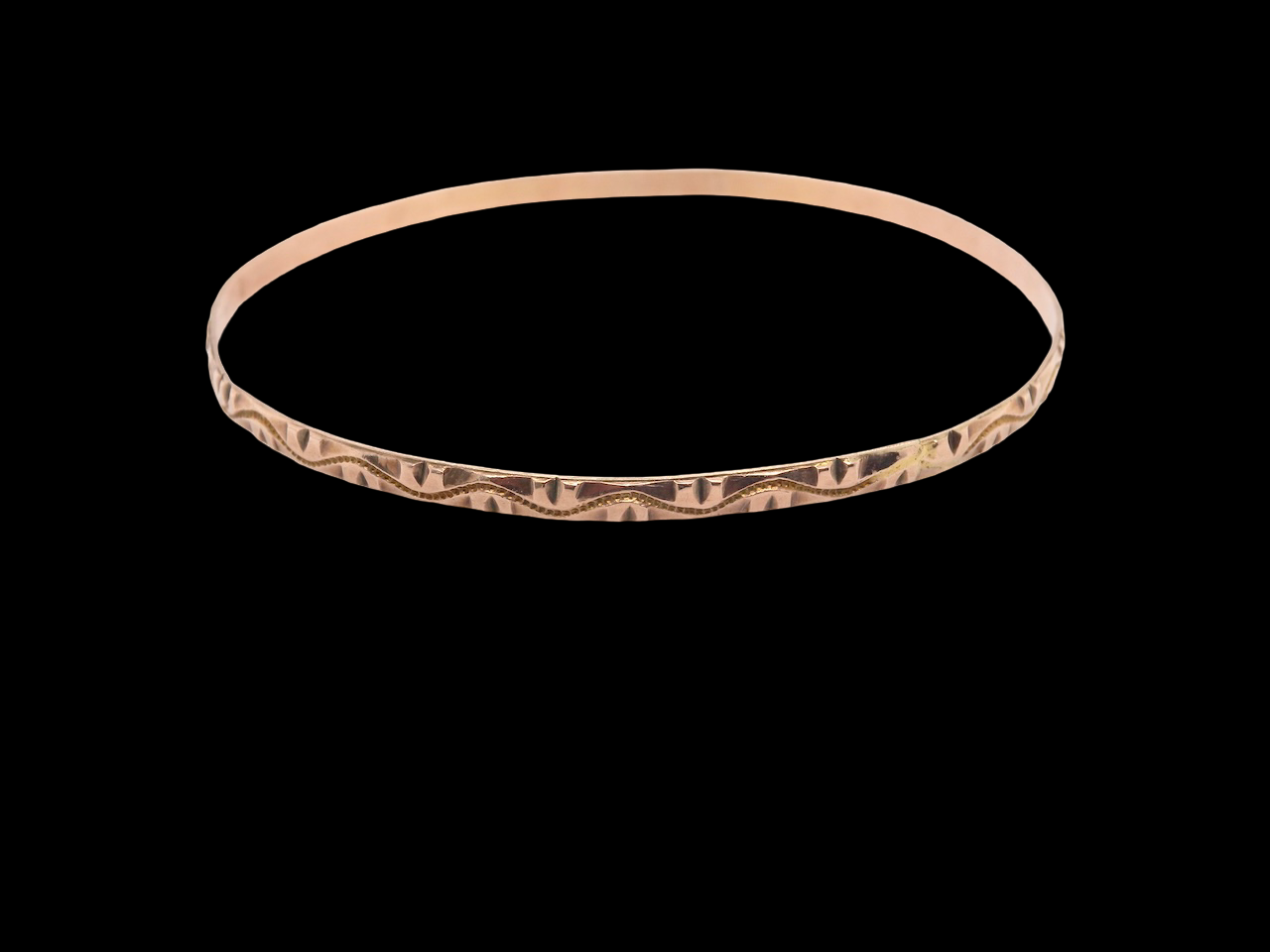 A narrow gold bangle
