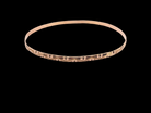 A narrow gold bangle