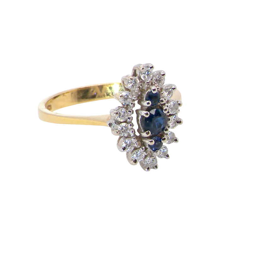 A navette shaped cluster ring. The centre a line of three sapphires, 0ne x 3.5mm, 2 x 1.5mm.
side