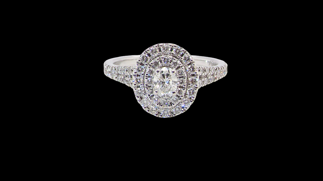 A new diamond cluster ring* An oval diamond halo cluster ring. Set with brilliant cut white diamonds,