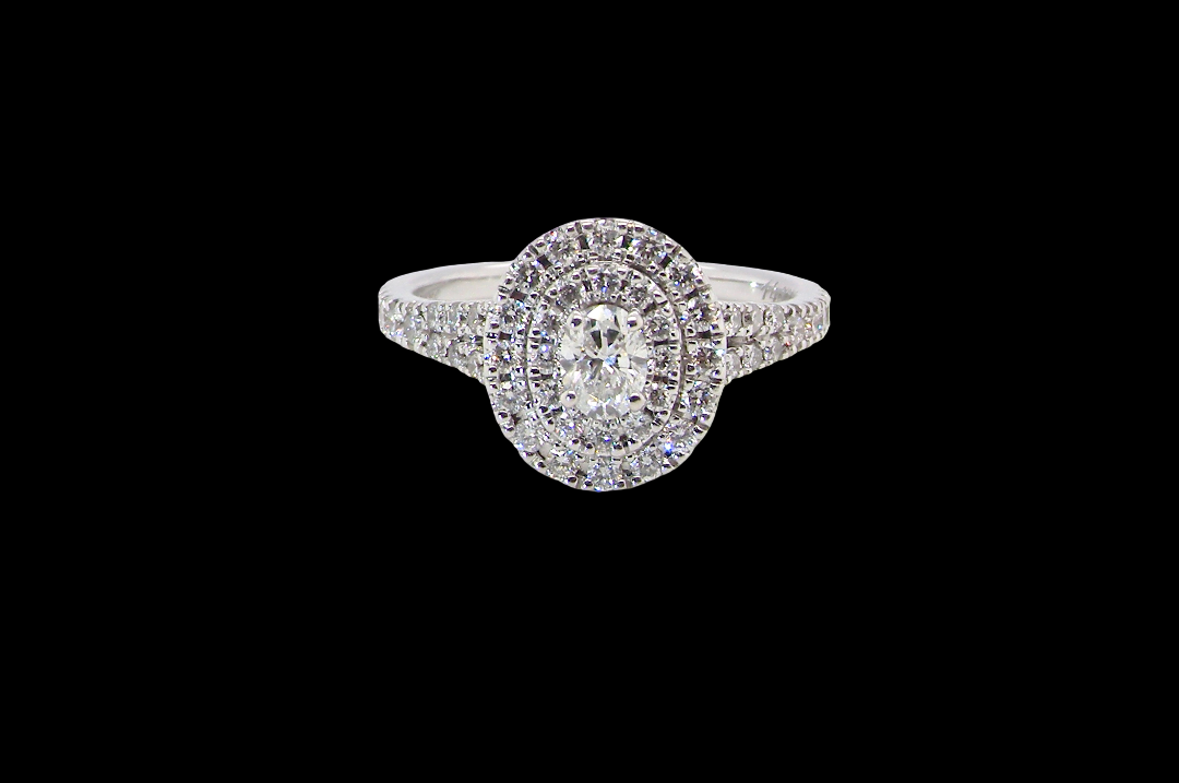 A new diamond cluster ring* An oval diamond halo cluster ring. Set with brilliant cut white diamonds,