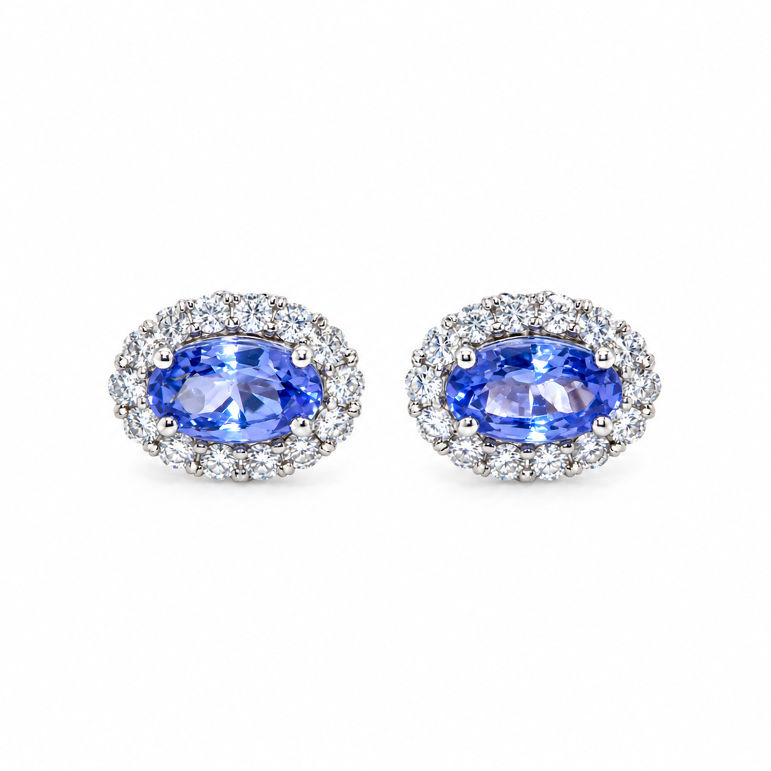 A pair of 18 carat white gold cluster earrings.
Features an oval tanzanite gemstone,