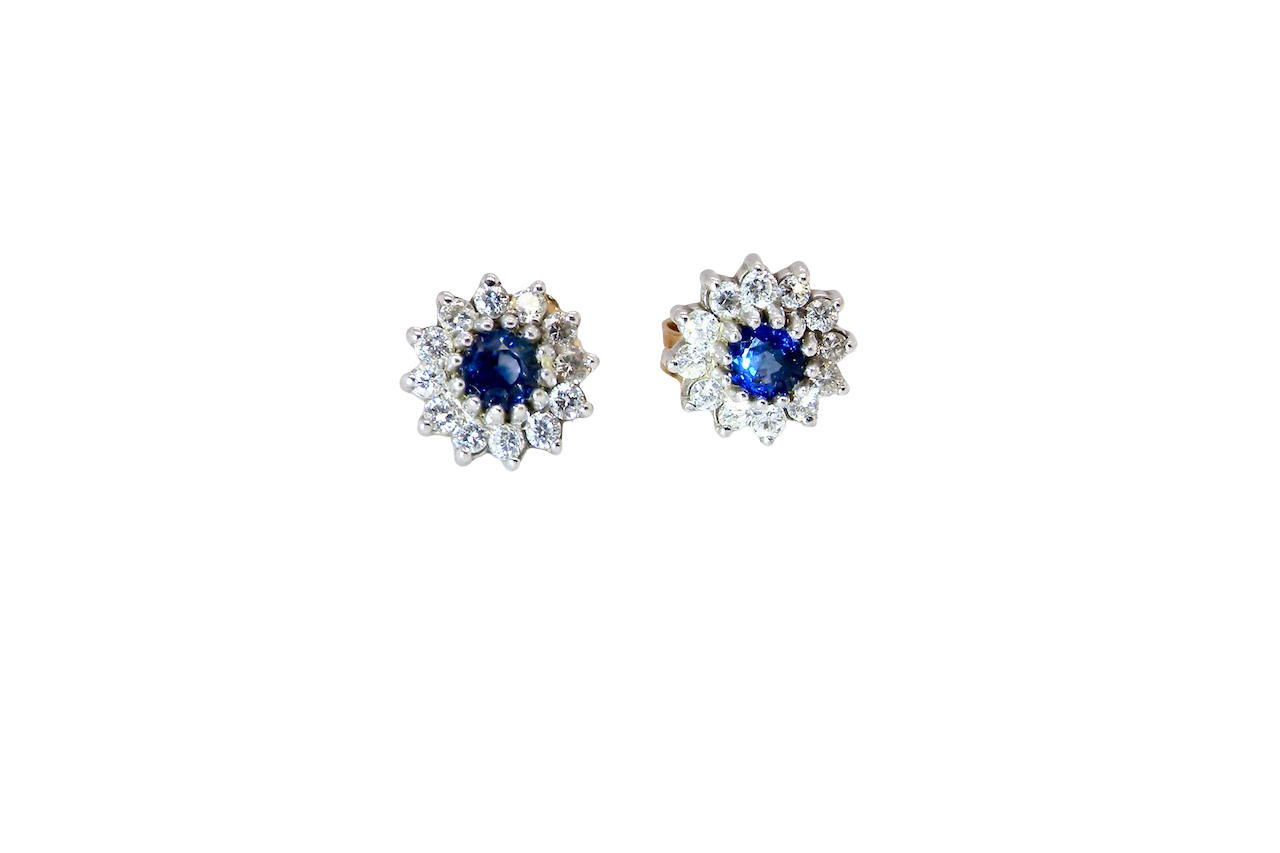 A pair of 9 carat gold earrings, each set with a sapphire centre stone,