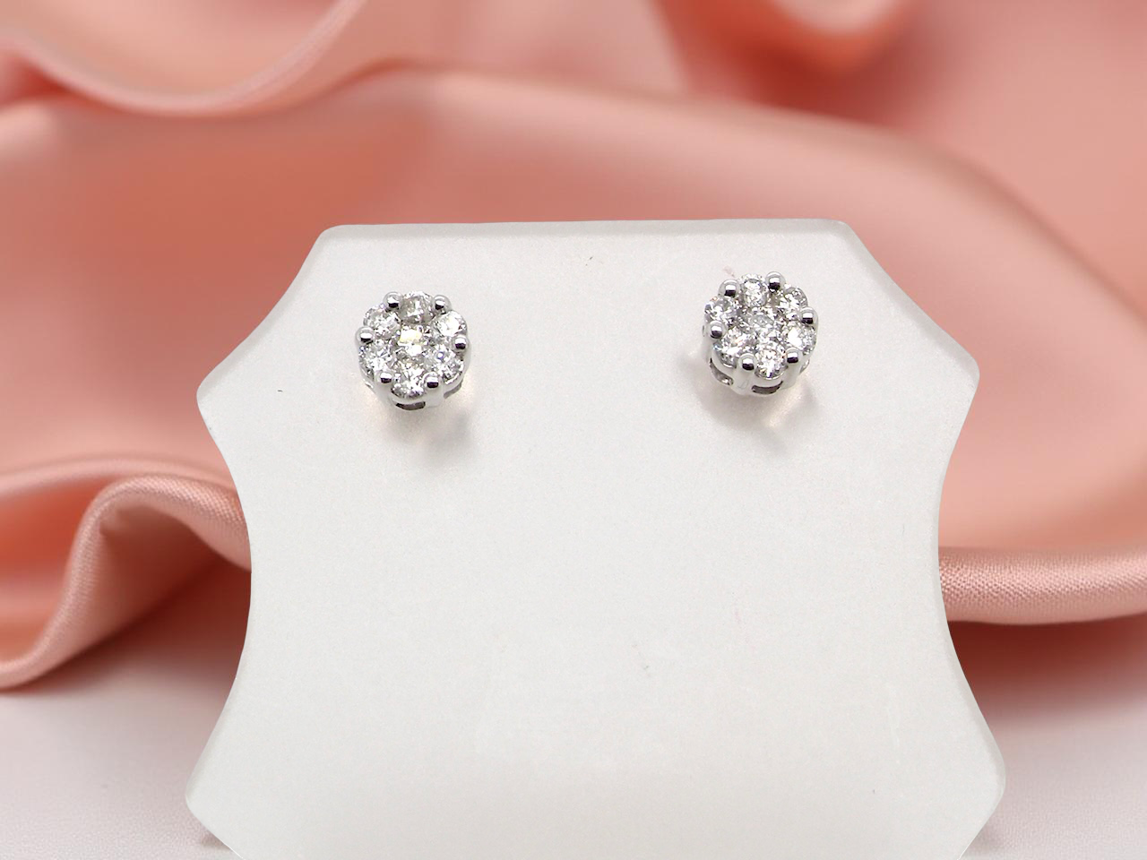 A pair of 9 carat white gold diamond stud earrings.
cluster
