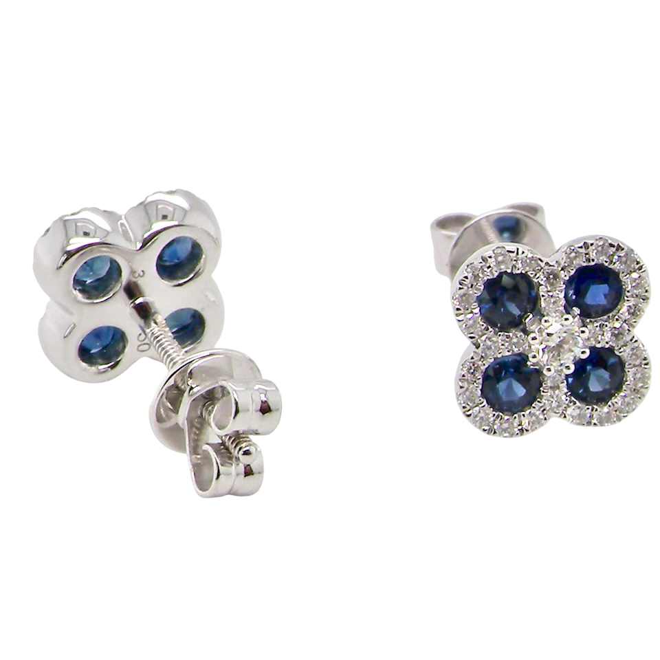 Pair of silver earrings with blue gemstones on a white background
