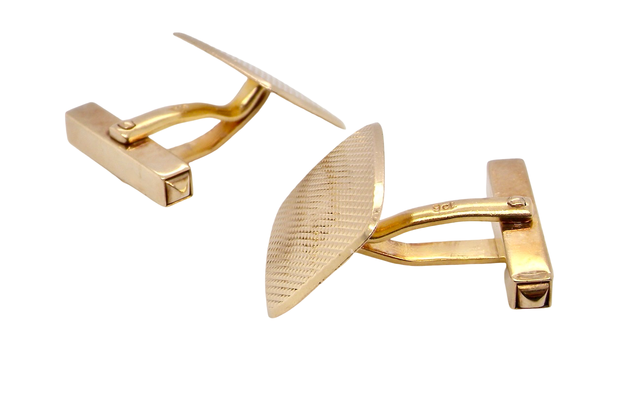 A pair of cushion shaped cufflinks. The head engine turned pattern.