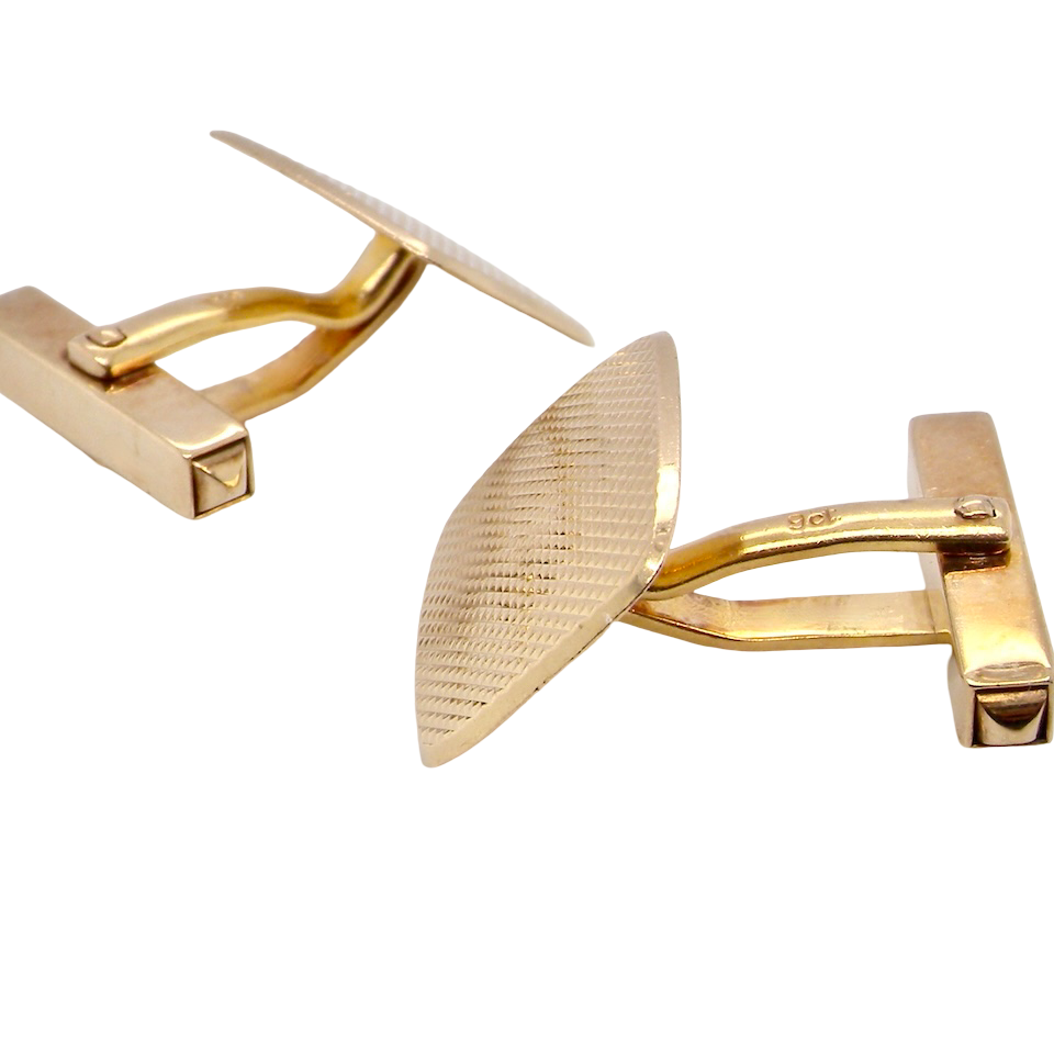 A pair of cushion shaped cufflinks. The head engine turned pattern.
