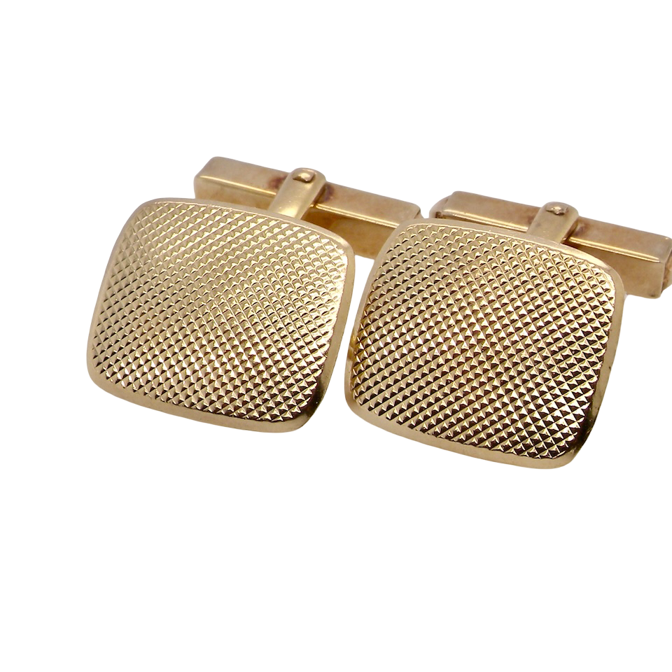 A pair of cushion shaped cufflinks. The head measures 17x15mm, engine turned pattern.