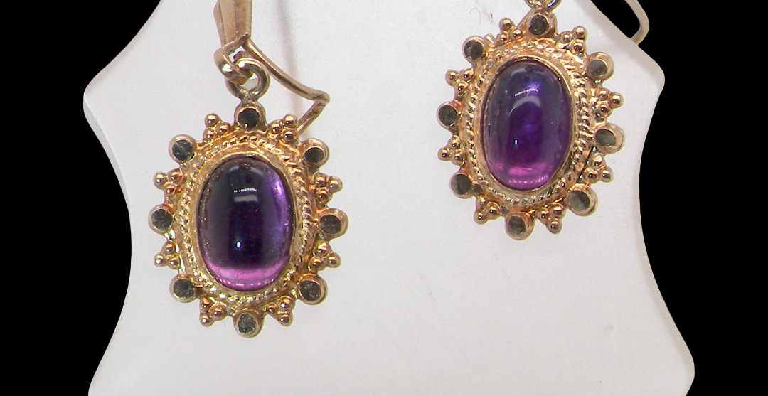 A pair of drop earrings. Each set with a cabouchon cut amethyst 6x4mm