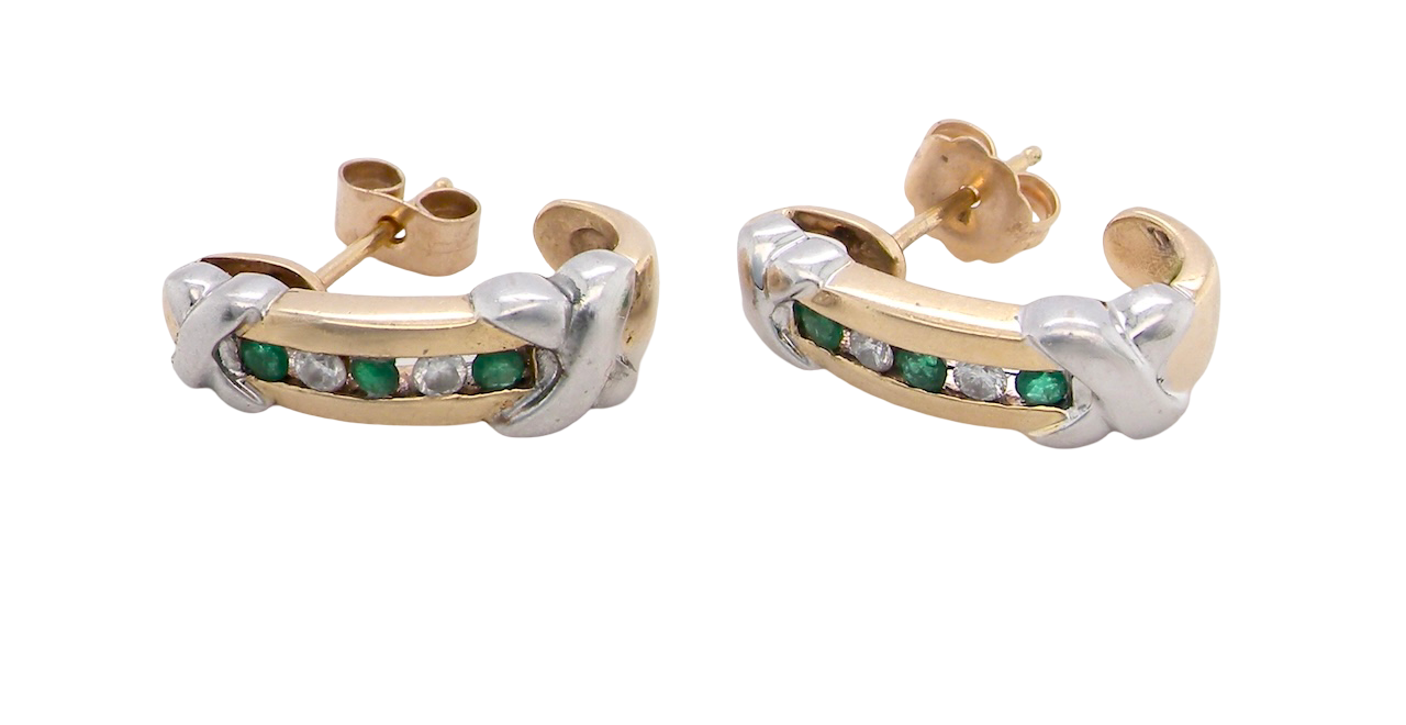 A pair of earrings, half hoop style. The centre a channel set with emeralds and diamonds,