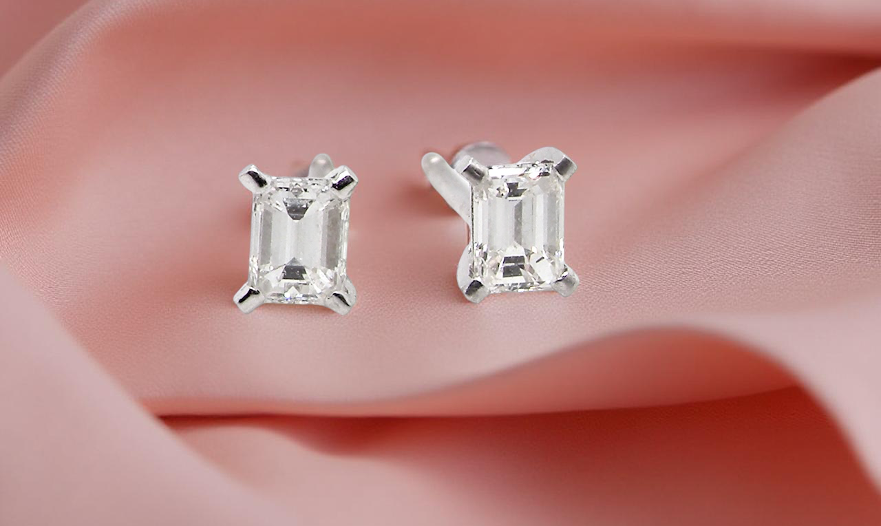 A pair of emerald cut diamond earrings