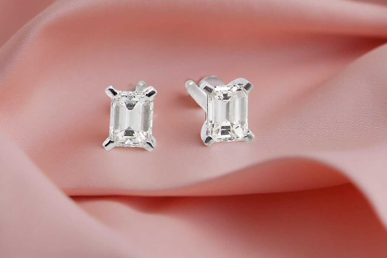 A pair of emerald cut diamond earrings