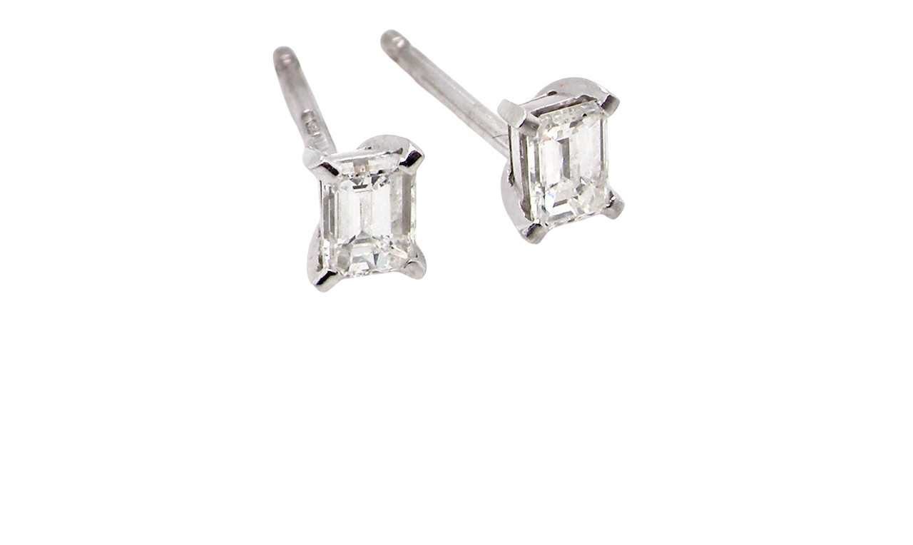 A pair of emerald cut diamond earrings