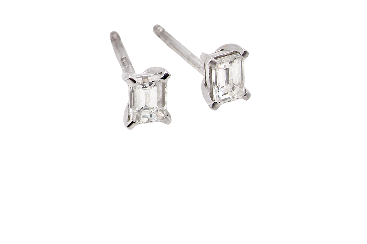 A pair of emerald cut diamond earrings