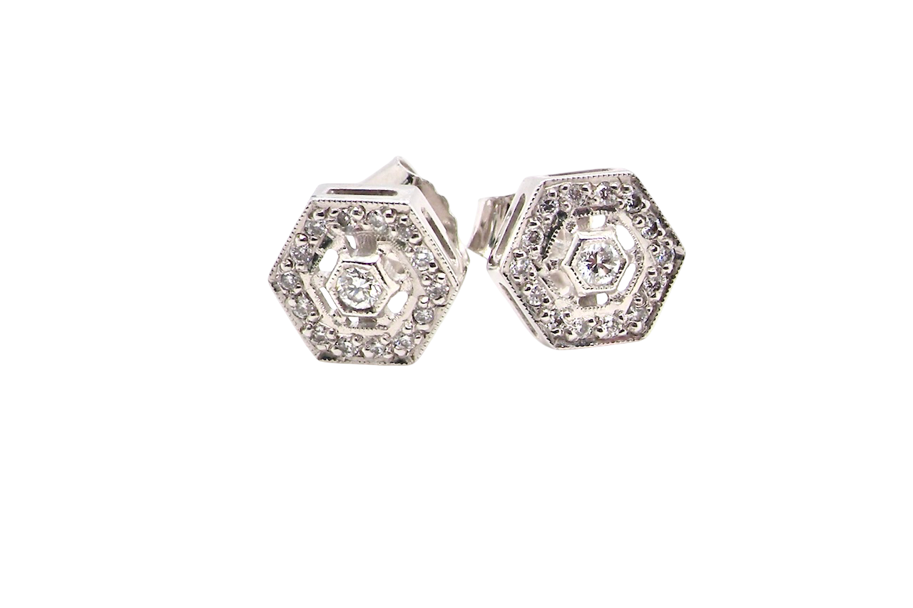 Hexagonal earrings with diamonds on a white background