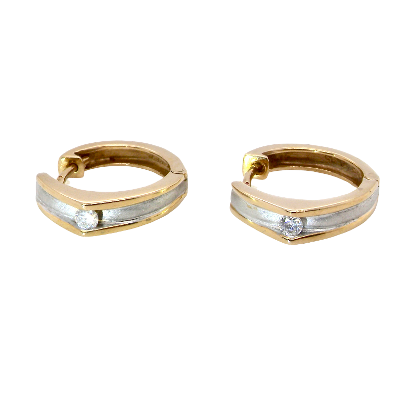 A pair of gold huggie hoop earrings with a textured silver-colored center channel and a small clear gemstone on each earring, shown against a plain white background.