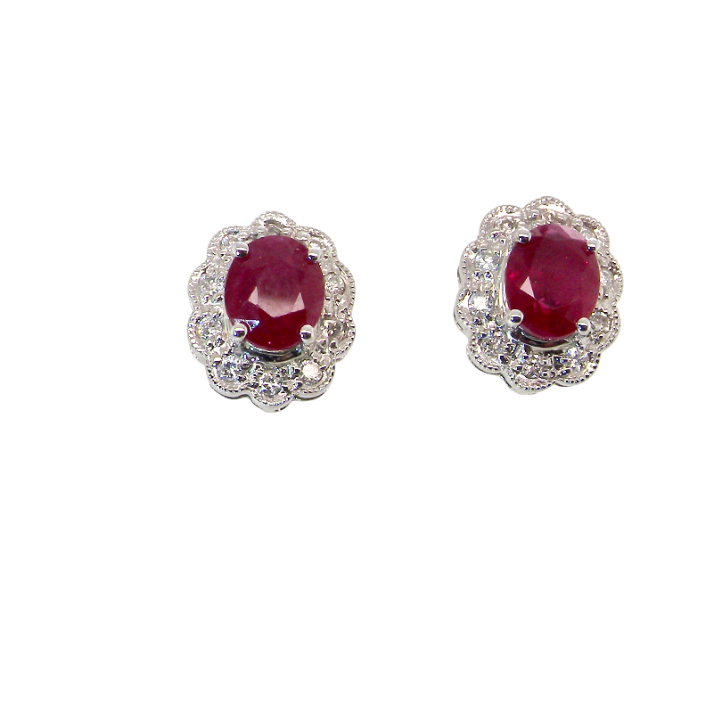 A pair of white gold earrings, each set with an oval ruby 6x4.9mm (est 0.60 carats) complimented by an outer halo of ten 1.5mm diamonds