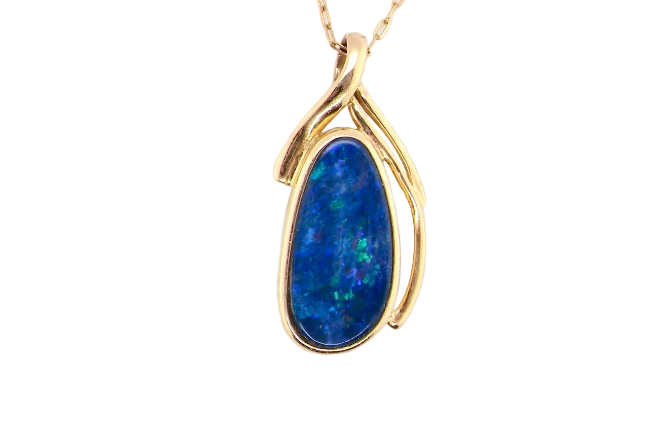 A pendant containing an oval shaped black opal