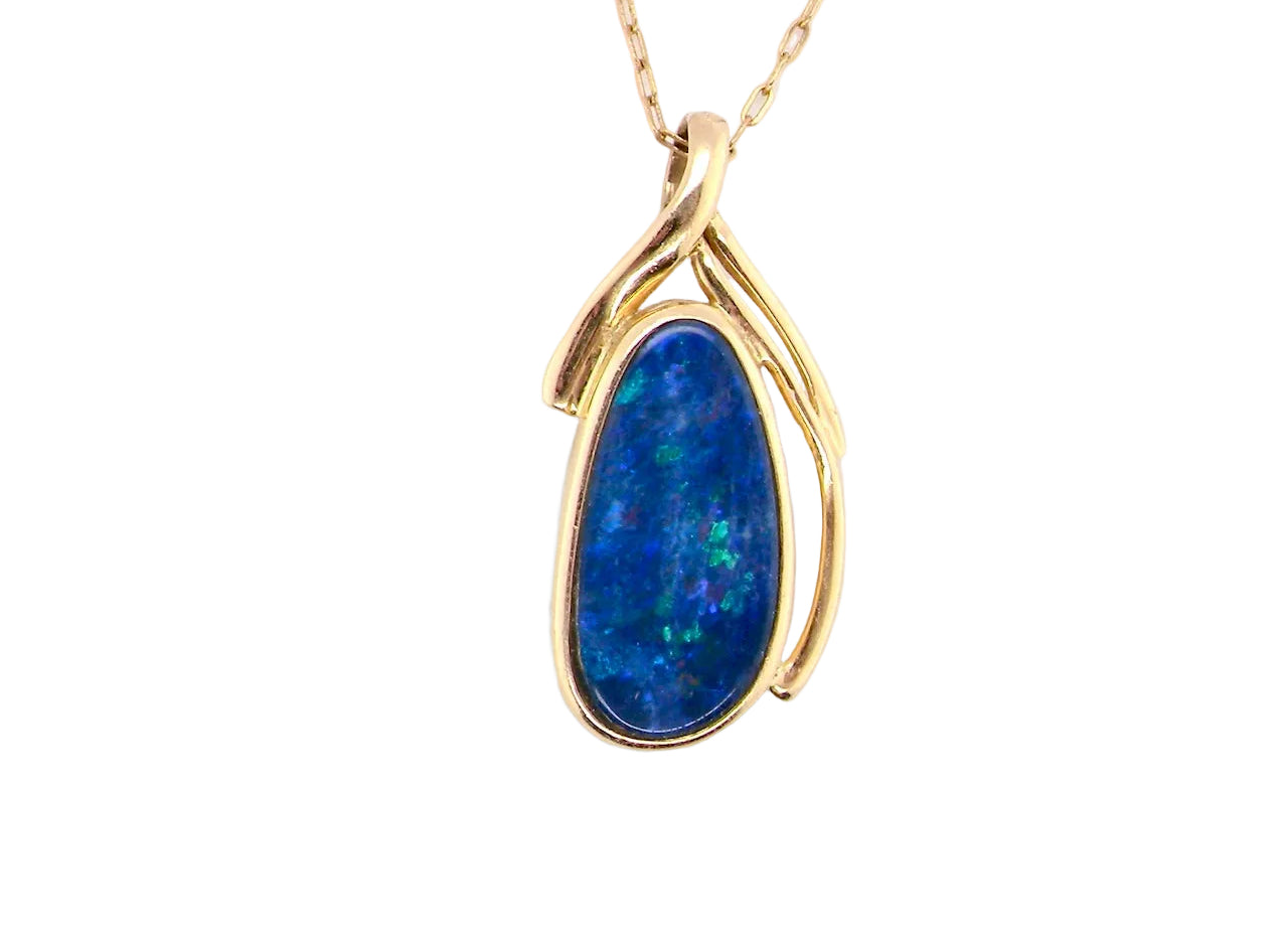 A pendant containing an oval shaped black opal
