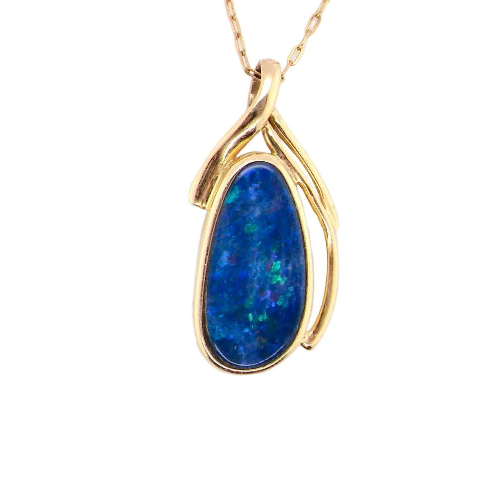 A pendant containing an oval shaped black opal