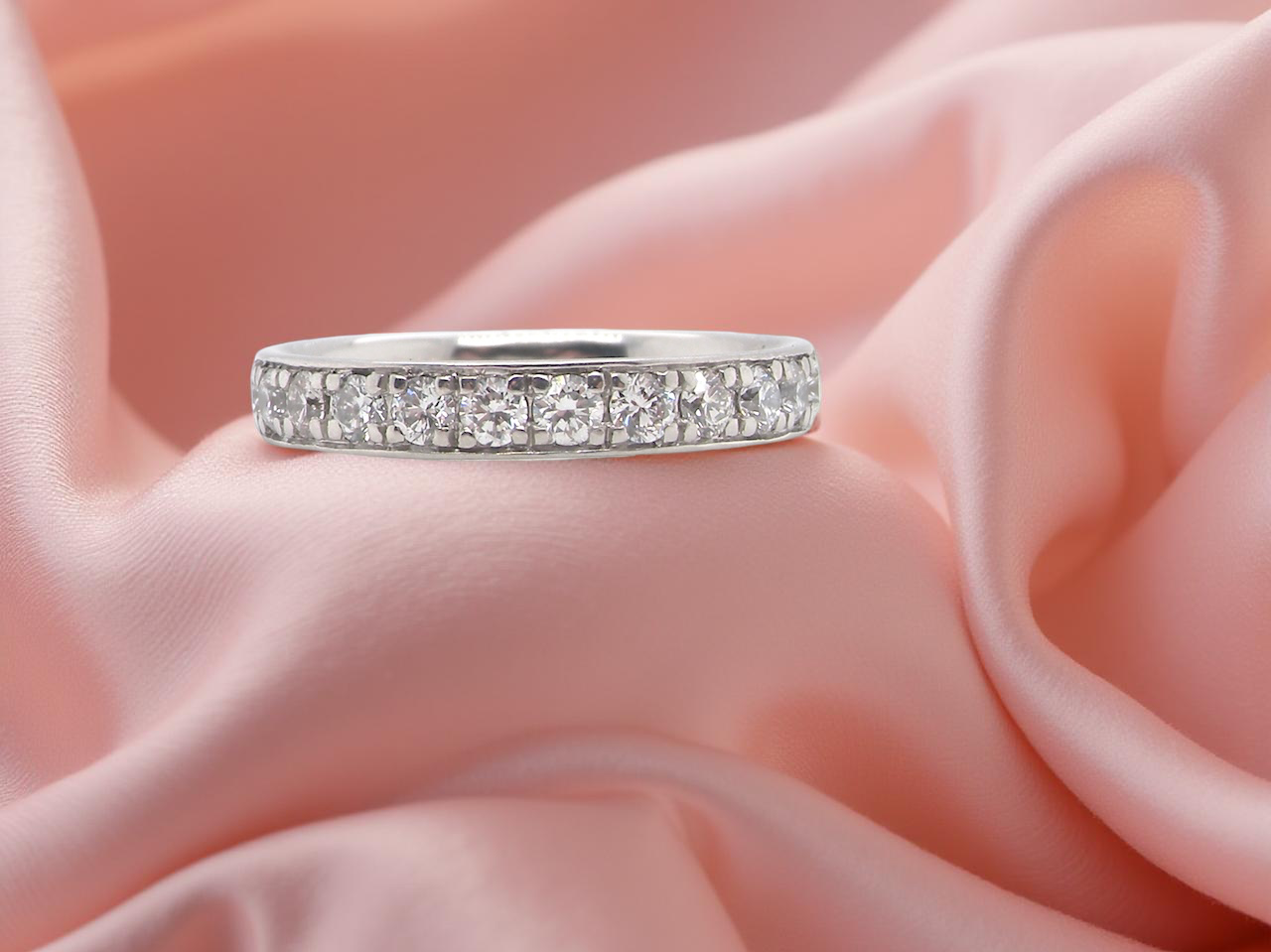 A platinum half hoop diamond eternity ring