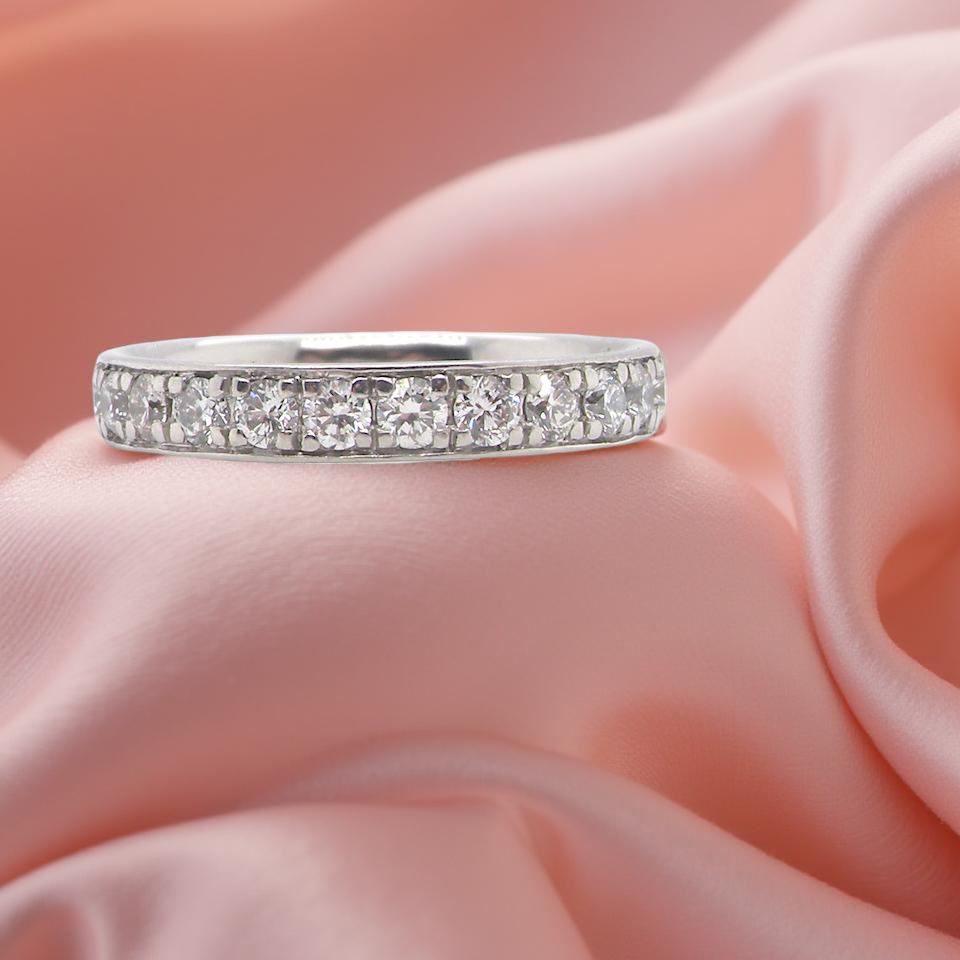 A platinum half hoop diamond eternity ring