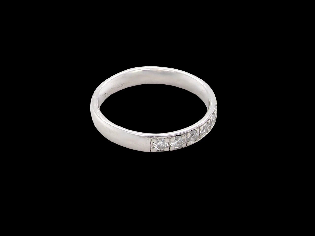 A platinum half hoop diamond eternity ring