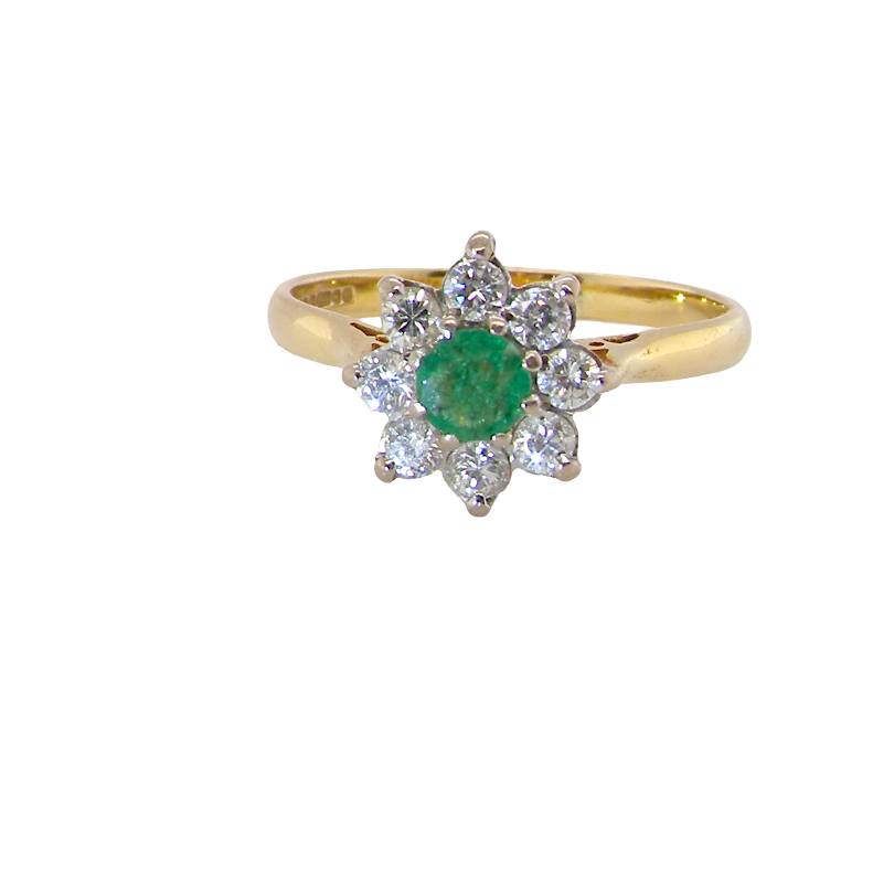 A pretty 18 carat gold cluster ring. The centre stone is a round emerald 4mm diameter (0.25 carats) mid green colour.