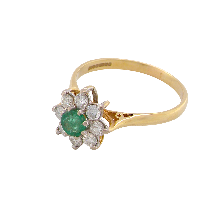 A vintage yellow gold ring featuring a central round green emerald gemstone surrounded by a halo of small round clear diamonds, set on a plain white background.