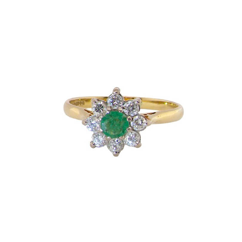 An emerald and diamond cluster ring