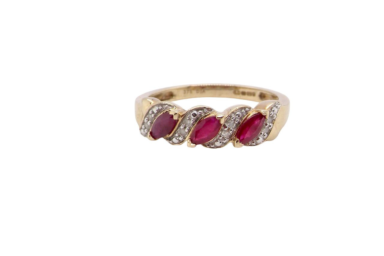 A pretty 9 carat gold dress ring. The three rubies are marquise cut, 5x3mm each, and set at an angle .