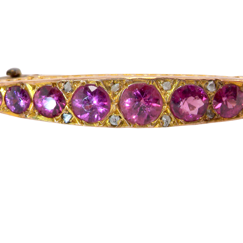 A Victorian crescent shaped brooch. The principal stones are almandine garnets