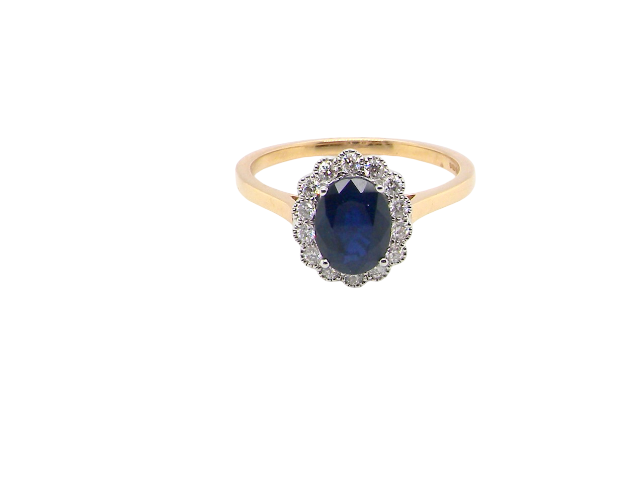 A pretty cluster ring that features an inky black blue sapphire that measures 8x6mm. Complimented by an outer border of 2mm diamonds