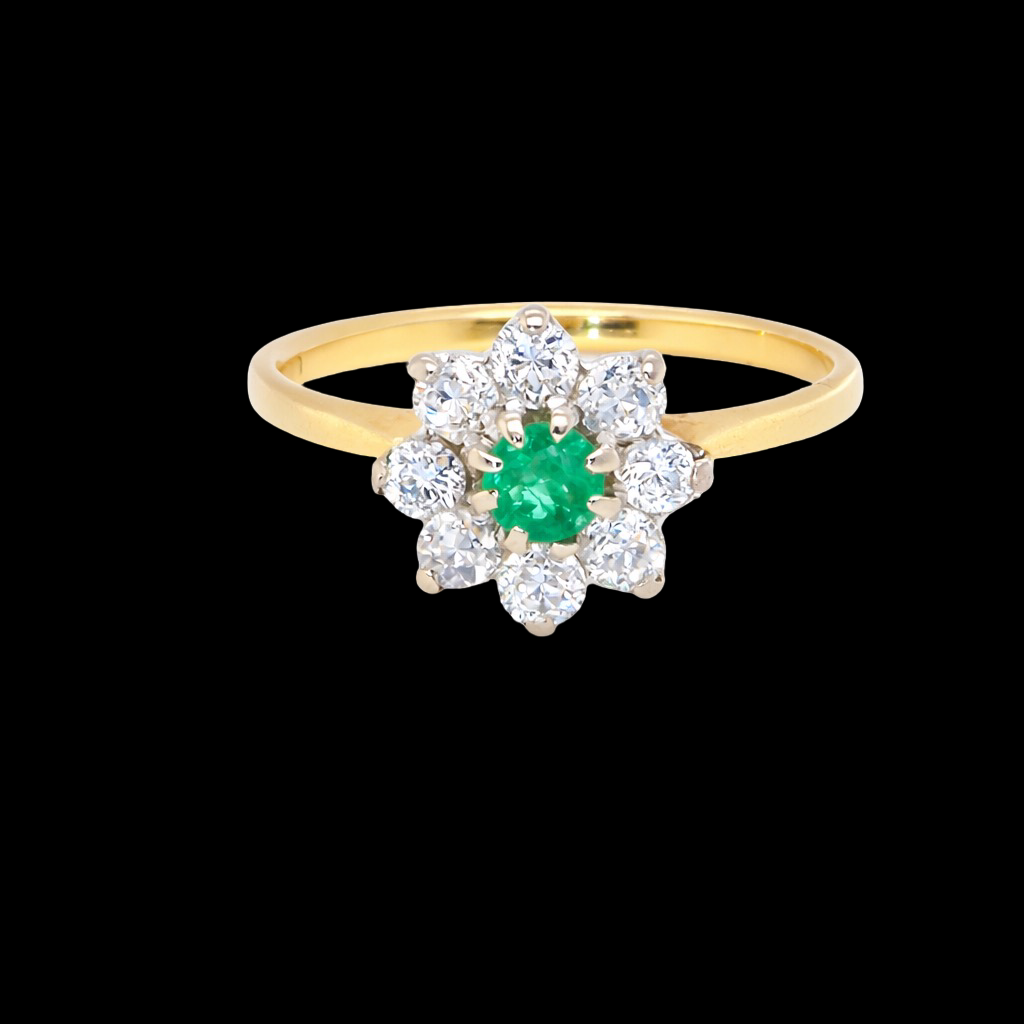 A pretty cluster ring that features to the centre a round emerald with diamonds