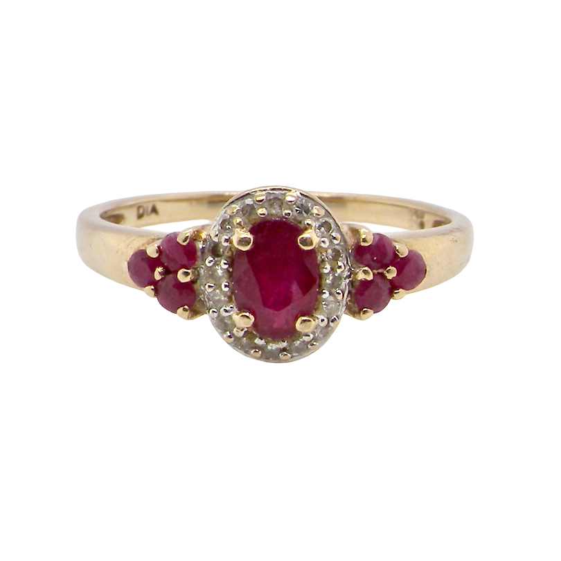A pretty cluster ring that features to the centre an oval cut ruby, 5x4mm, retained by four claws and an outer halo of sixteen small white diamonds, each 1.3mm