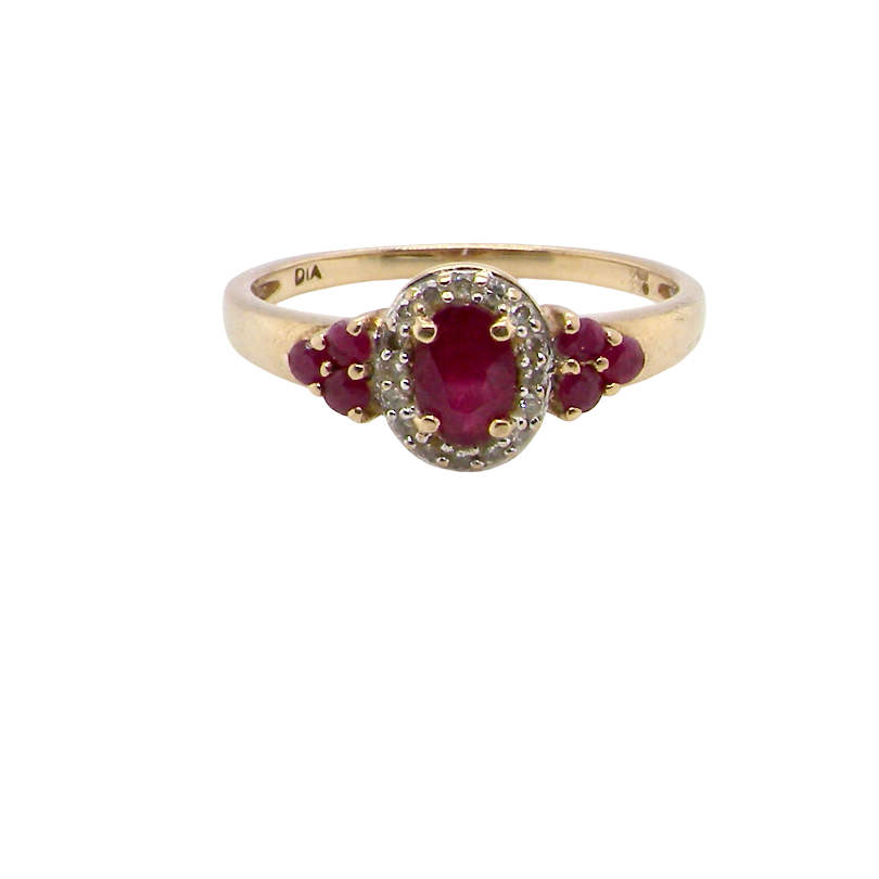 A pretty cluster ring that features to the centre an oval cut ruby, 5x4mm, retained by four claws and an outer halo of sixteen small white diamonds, each 1.3mm (total estimated at 0.15 carats) 