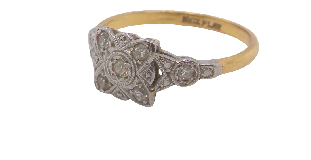 A pretty diamond cluster ring from the early part of the 20th century. A square head that has within it small white diamonds, measures 8x8mm, fancy shoulders also set with tiny diamonds.side