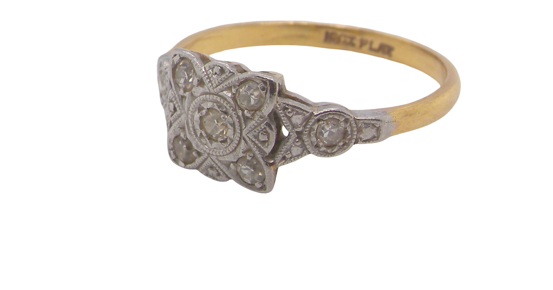 A pretty diamond cluster ring from the early part of the 20th century. A square head that has within it small white diamonds, measures 8x8mm, fancy shoulders also set with tiny diamonds.side