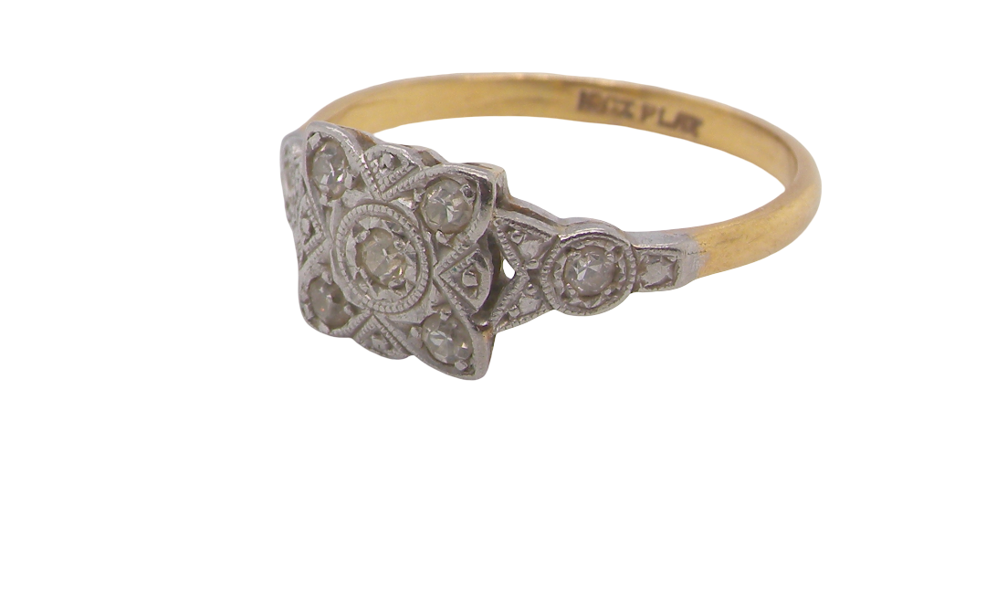 A pretty diamond cluster ring from the early part of the 20th century. A square head that has within it small white diamonds, measures 8x8mm, fancy shoulders also set with tiny diamonds.side