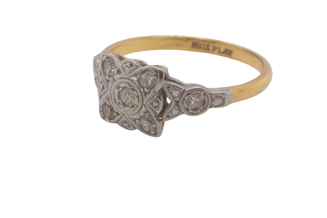 A pretty diamond cluster ring from the early part of the 20th century. A square head that has within it small white diamonds, measures 8x8mm, fancy shoulders also set with tiny diamonds.side