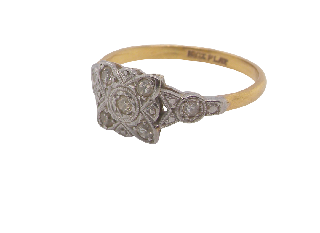 A pretty diamond cluster ring from the early part of the 20th century. A square head that has within it small white diamonds, measures 8x8mm, fancy shoulders also set with tiny diamonds.side