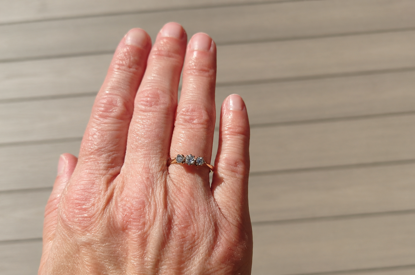 A pretty diamond trilogy ring on a hand