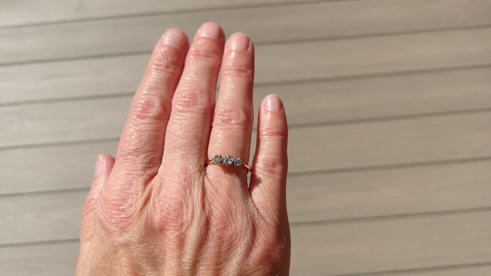 A pretty diamond trilogy ring on a hand