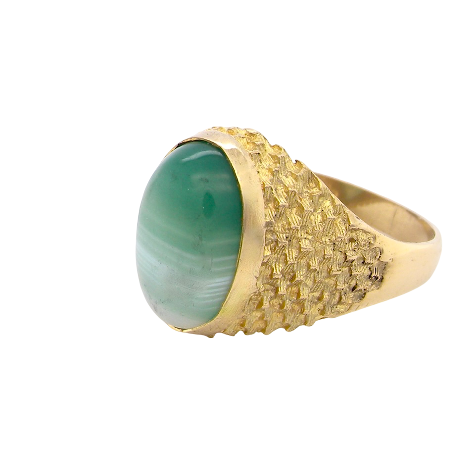 A pretty dress ring. Set with a cabouchon cut banded green agate , colours from jade green with stripes