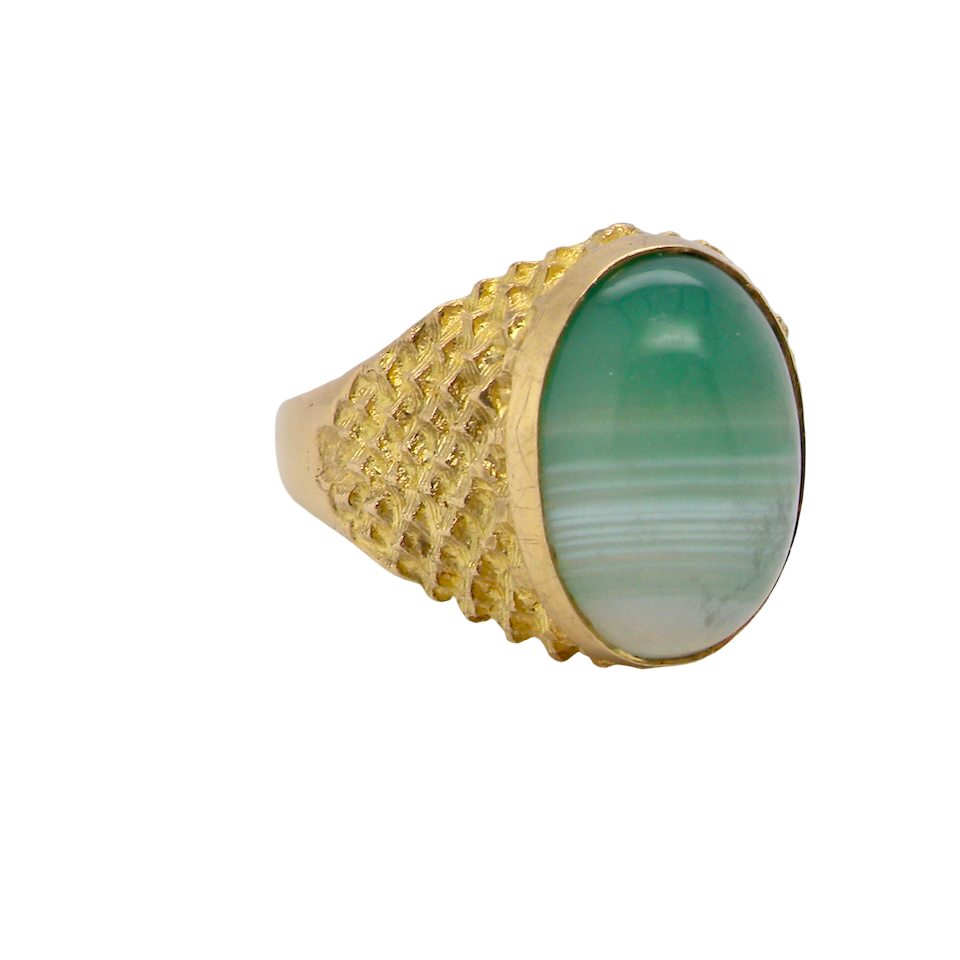 A pretty dress ring. Set with a cabouchon cut banded green agate , colours from jade green with stripes down to the base turning to white.