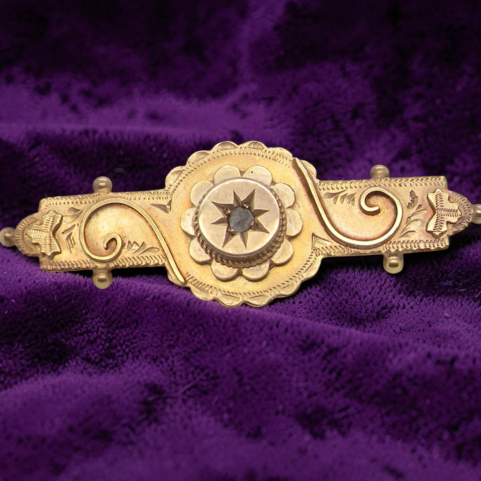 A pretty late Victorian bar brooch. Applied piqué work makes this brooch so attractive