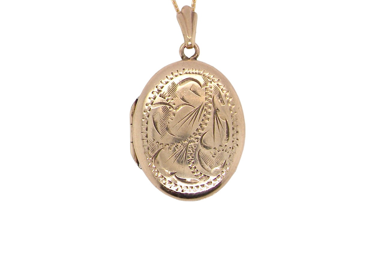 A pretty oval shaped locket. Measures 22x17mm. Hand engraved front, plain reverse