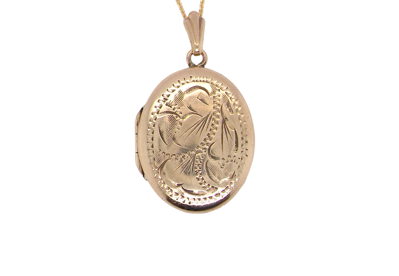 A pretty oval shaped locket. Measures 22x17mm. Hand engraved front, plain reverse