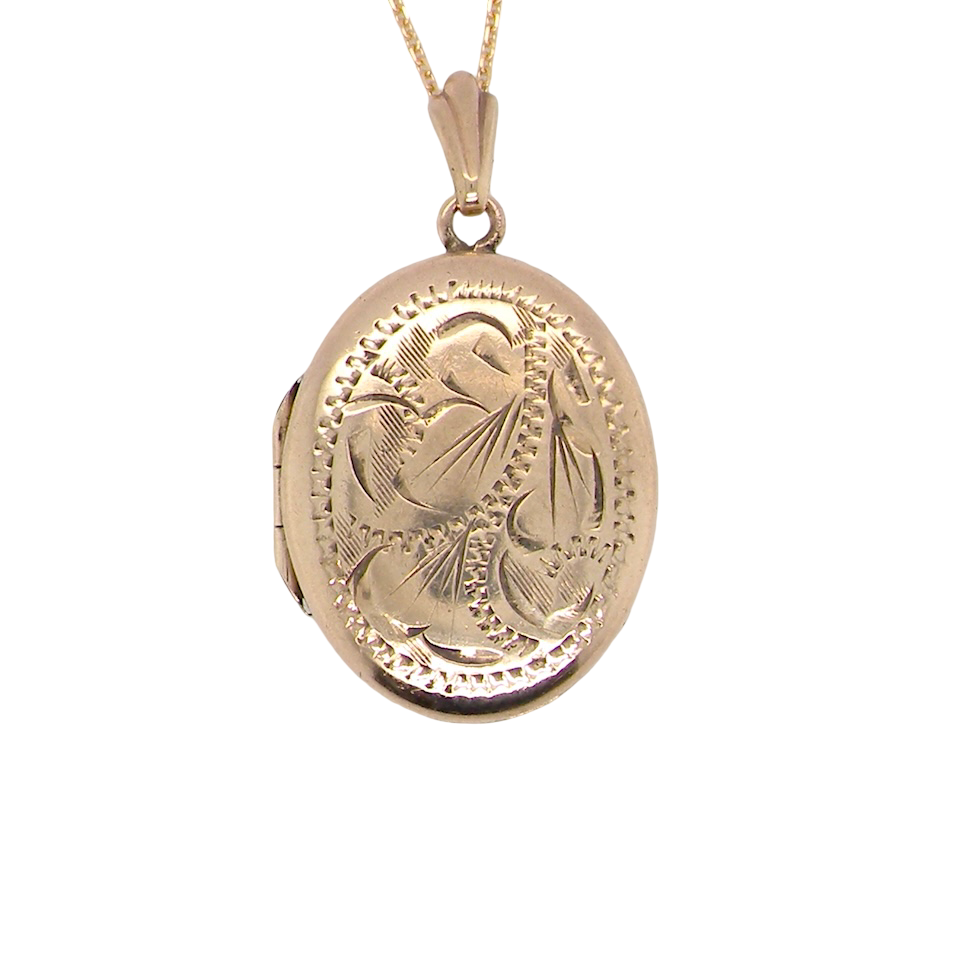 A pretty oval shaped locket. Measures 22x17mm. Hand engraved front, plain reverse