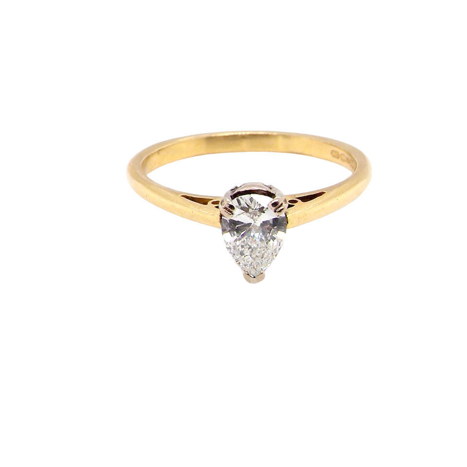 Gold ring with a teardrop-shaped diamond on a white background